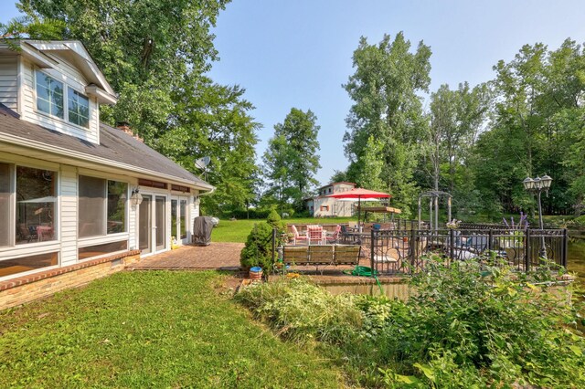 4705 Weiss Rd, Frankenmuth, MI 48734 - view of green lawn featuring a patio, view of scattered trees, and french doors