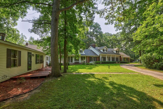 4705 Weiss Rd, Frankenmuth, MI 48734 - view of front of property with a front lawn and a deck
