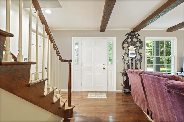 foyer entrance with beam ceiling, dark hardwood / wood-style flooring, and crown molding