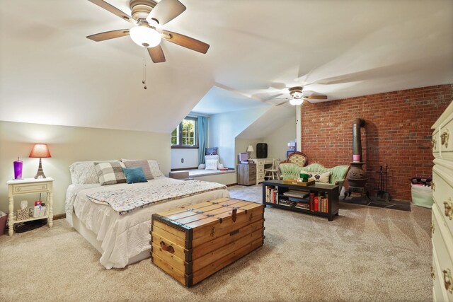4705 Weiss Rd, Frankenmuth, MI 48734 - carpeted bedroom featuring a wood stove, vaulted ceiling, and ceiling fan