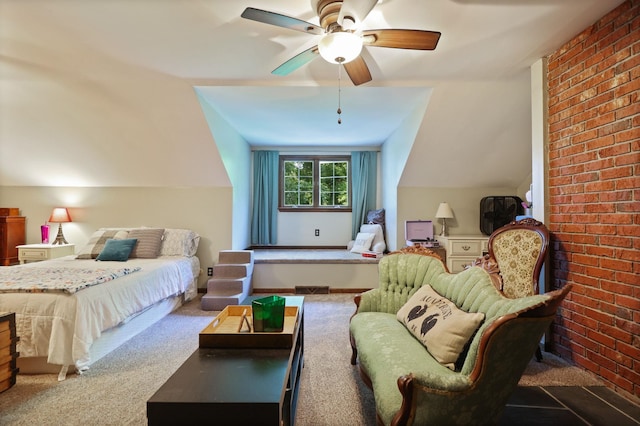 bedroom with ceiling fan, carpet floors, brick wall, and vaulted ceiling