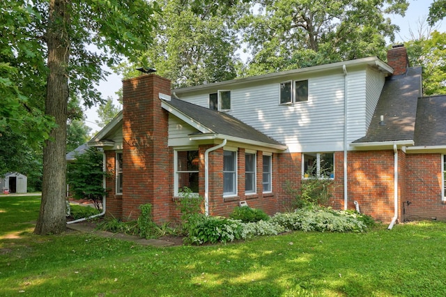 back of property featuring a lawn