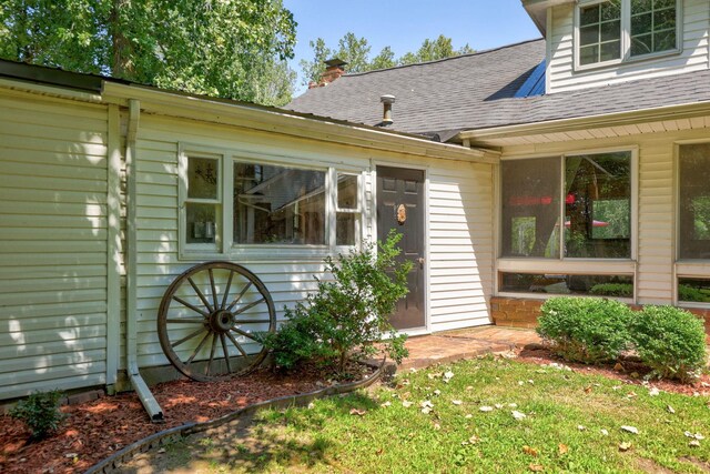 4705 Weiss Rd, Frankenmuth, MI 48734 - property entrance with roof with shingles, a chimney, and a yard