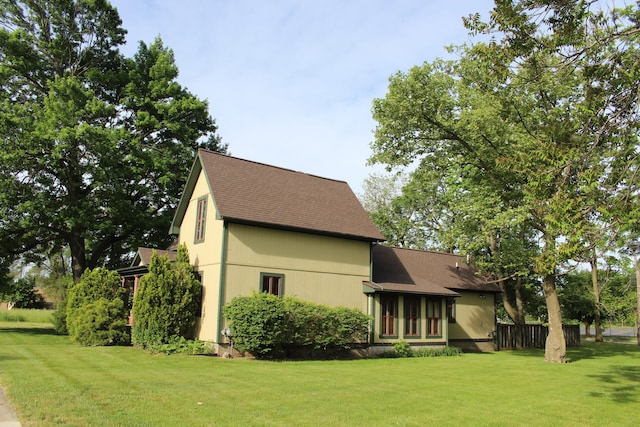 back of property featuring a yard