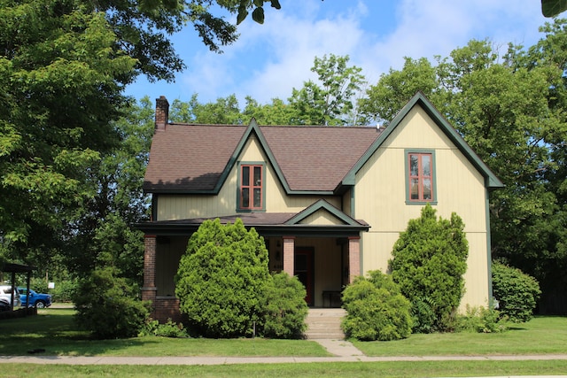 tudor-style house featuring a front yard