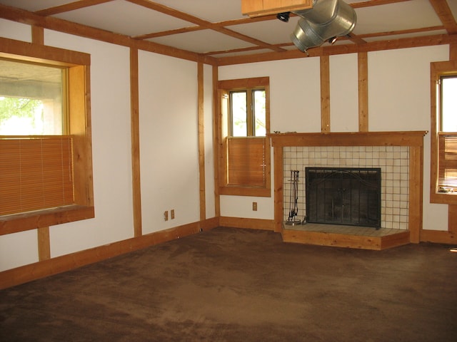 unfurnished living room featuring a tiled fireplace