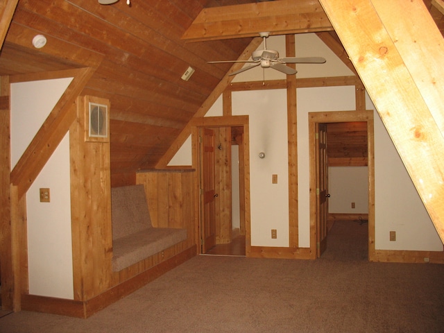 additional living space featuring carpet flooring, ceiling fan, lofted ceiling with beams, and wooden ceiling