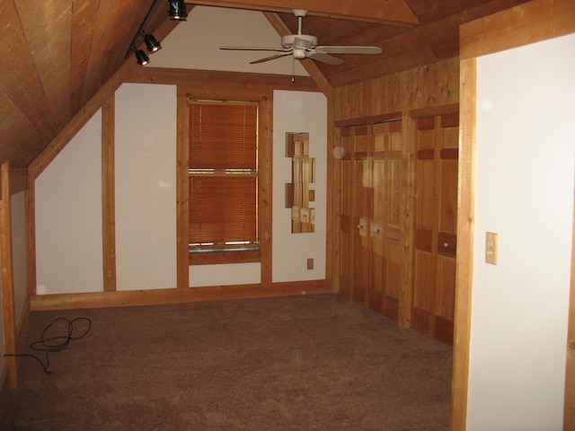 interior space featuring carpet, ceiling fan, lofted ceiling, and track lighting