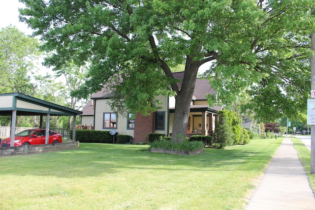 view of front of house featuring a carport and a front lawn