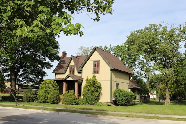 view of side of home with a yard