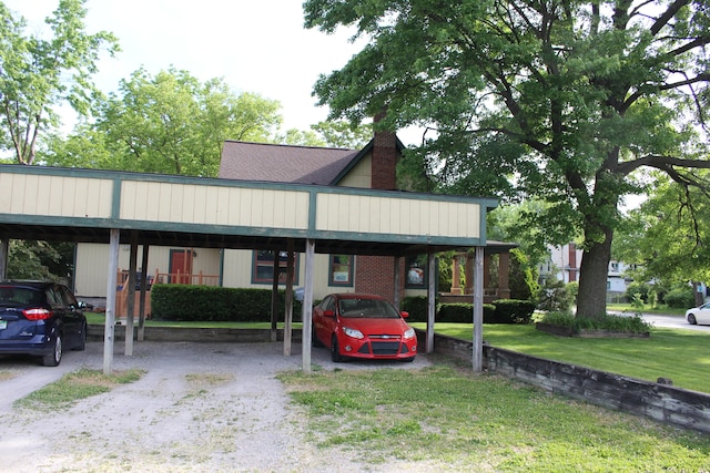 view of car parking featuring a yard and a carport