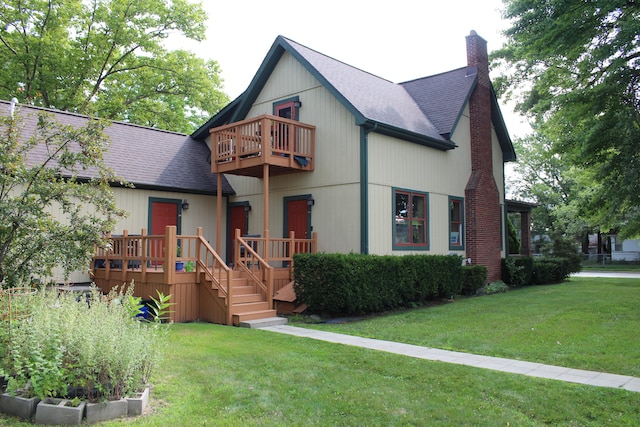 view of front of home with a front yard and a balcony