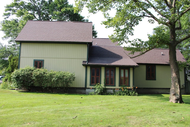 back of house with a lawn