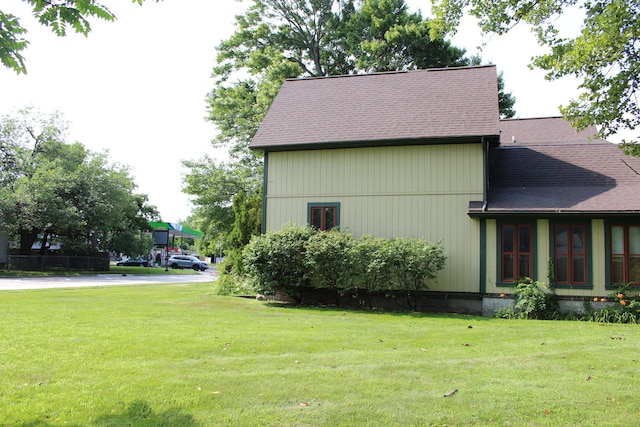 view of property exterior with a yard