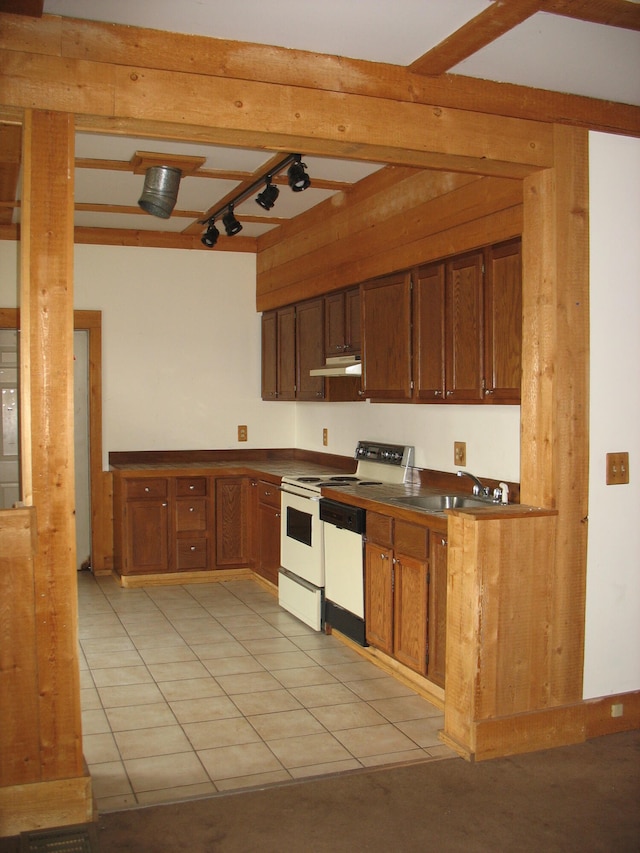 kitchen featuring beam ceiling, sink, light tile patterned floors, and white appliances