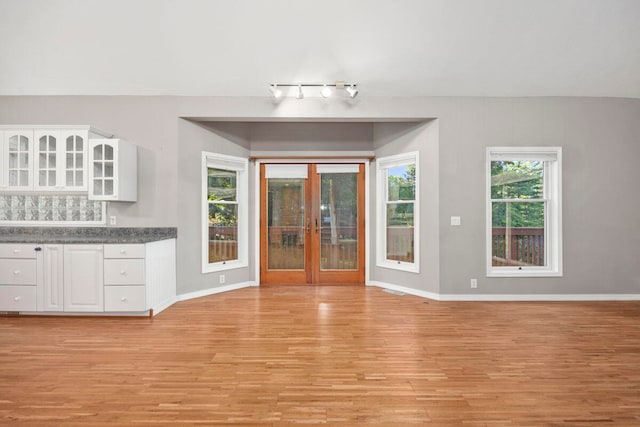 interior space with french doors and light hardwood / wood-style floors