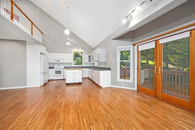 kitchen with white cabinetry, white appliances, high vaulted ceiling, and light hardwood / wood-style flooring