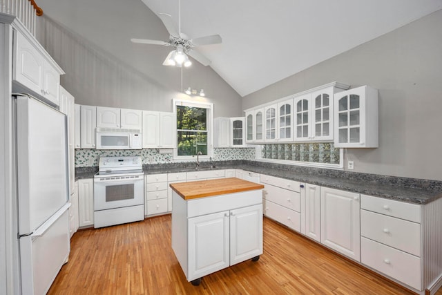 kitchen featuring white cabinetry, light hardwood / wood-style flooring, ceiling fan, and white appliances