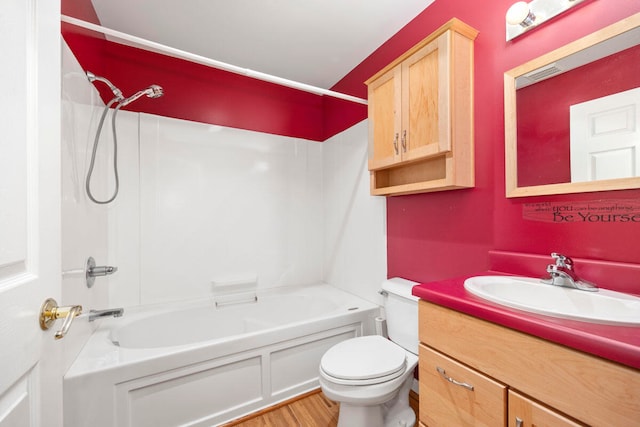 full bathroom with hardwood / wood-style floors, vanity, toilet, and tub / shower combination