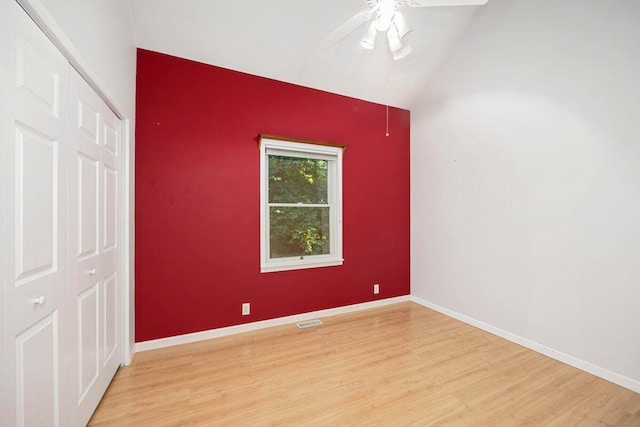 empty room featuring ceiling fan, light hardwood / wood-style floors, and lofted ceiling