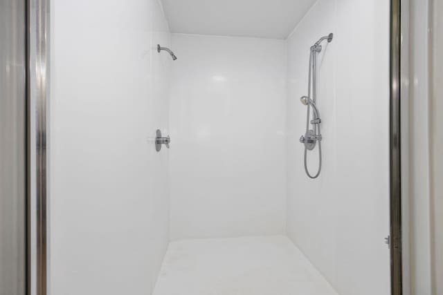 bathroom with a tile shower