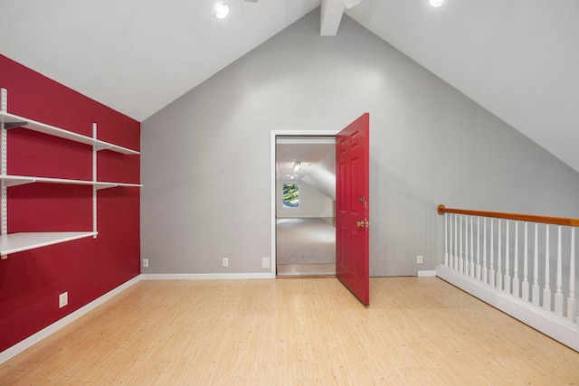 interior space with hardwood / wood-style floors and lofted ceiling with beams