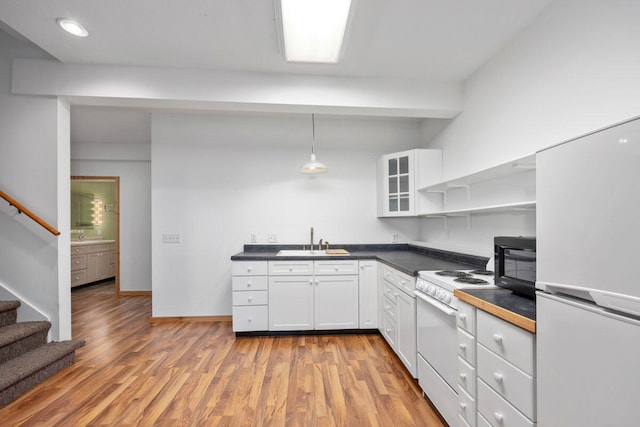 kitchen with white cabinetry, white appliances, sink, and light hardwood / wood-style flooring