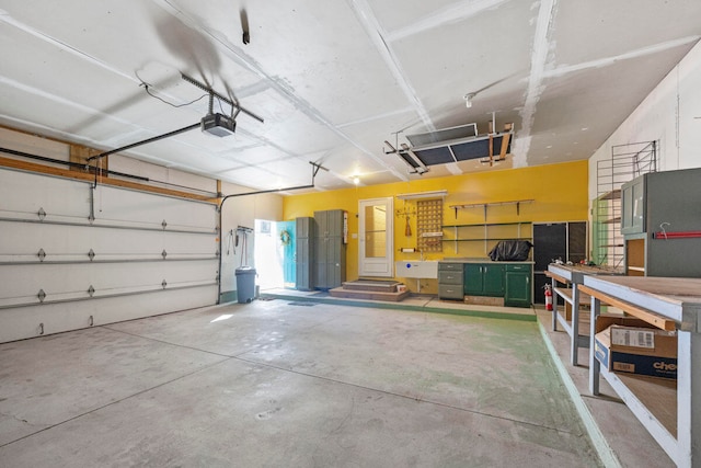 garage with a workshop area and a garage door opener