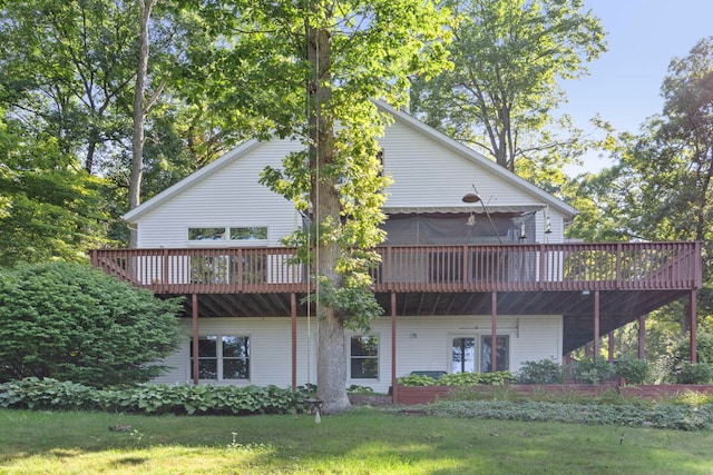 rear view of property with a lawn and a wooden deck