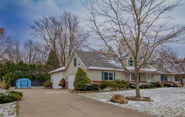 view of front of house with a garage and a storage unit