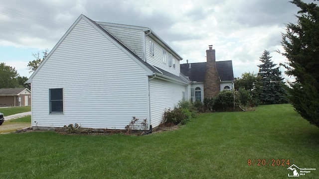 view of property exterior with a yard