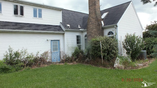 rear view of property with a lawn