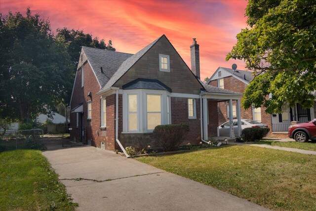 bungalow-style home with a yard