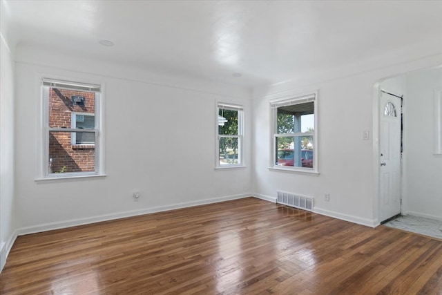 unfurnished room featuring dark hardwood / wood-style floors