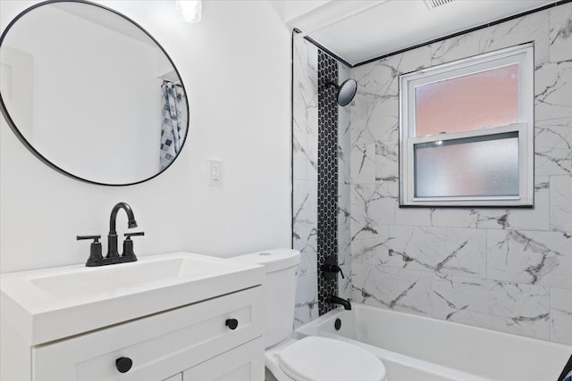 full bathroom with vanity, toilet, and tiled shower / bath