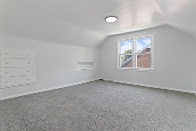 bonus room with carpet and lofted ceiling