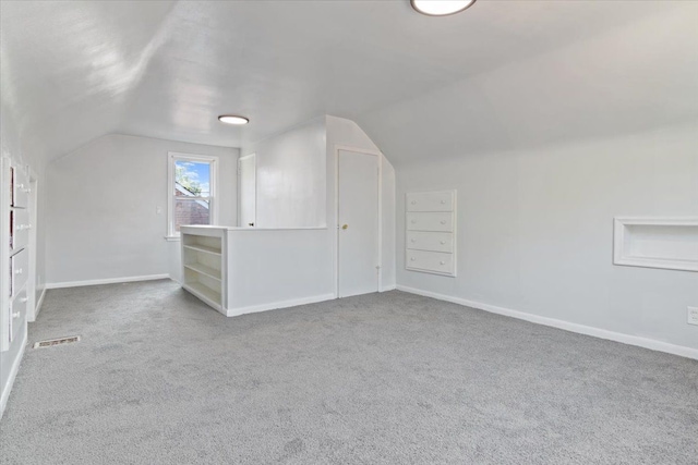 bonus room with carpet flooring and lofted ceiling