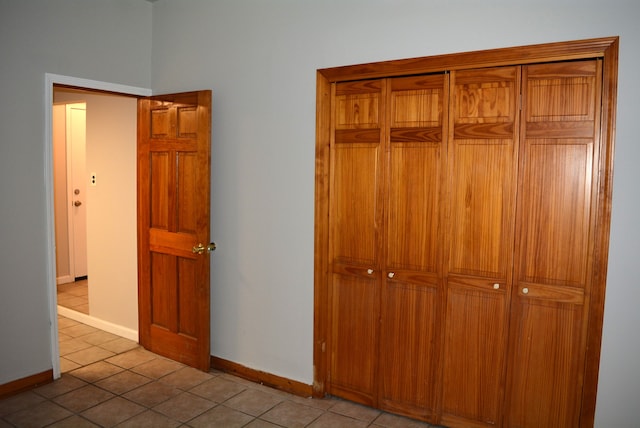 unfurnished bedroom featuring a closet and light tile patterned floors