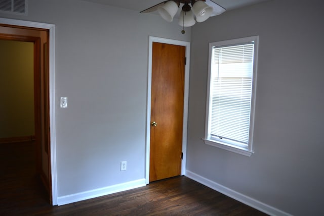 unfurnished bedroom featuring dark hardwood / wood-style floors and ceiling fan