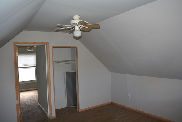 additional living space featuring ceiling fan, dark carpet, and lofted ceiling