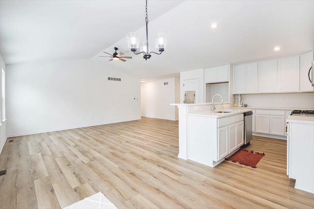 kitchen with vaulted ceiling, sink, white cabinetry, pendant lighting, and an island with sink