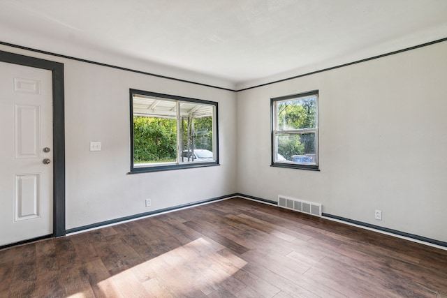 spare room featuring dark hardwood / wood-style flooring