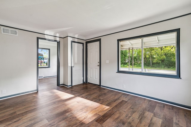 spare room featuring dark wood-type flooring