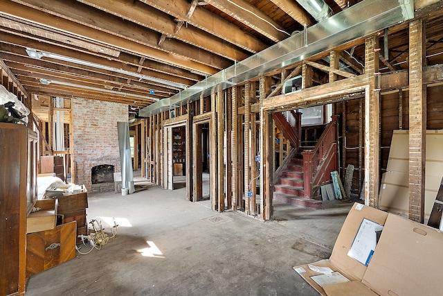 miscellaneous room with a fireplace and brick wall