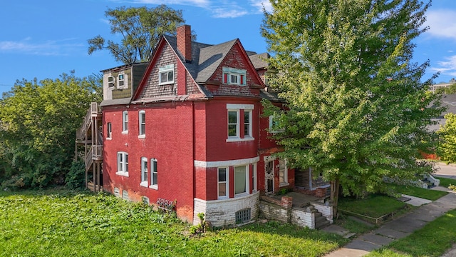414 Horton St, Detroit, MI 48202 - view of property exterior featuring a chimney and brick siding