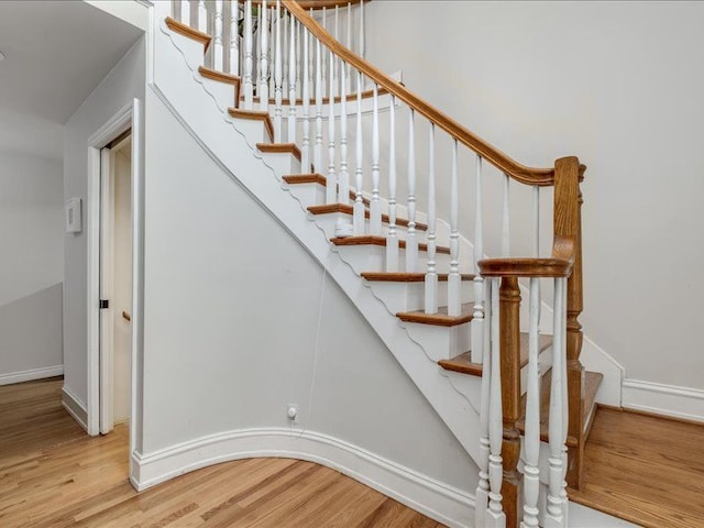 stairs with hardwood / wood-style floors