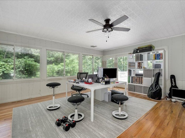 interior space with a textured ceiling, light wood-type flooring, a wealth of natural light, and ceiling fan