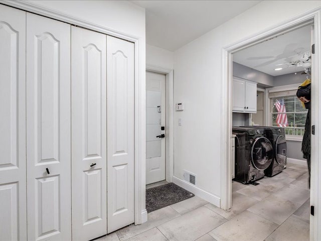 washroom with light tile patterned floors, cabinets, and independent washer and dryer