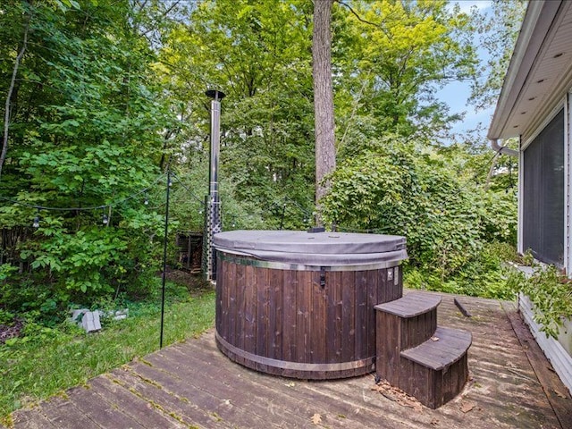 wooden deck with a hot tub