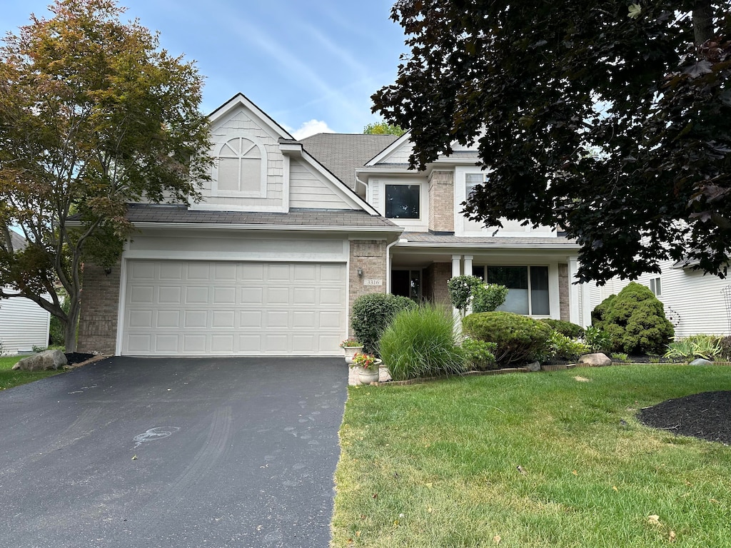 view of front of home with a front yard and a garage